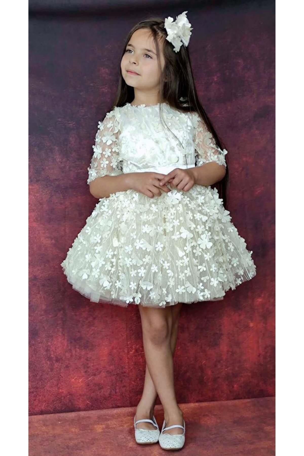 Kız Çocuk Kolları Şeffaf Tüllü ve Üzeri Papatya Motifli Beli Şerit Detaylı Krem Elbise